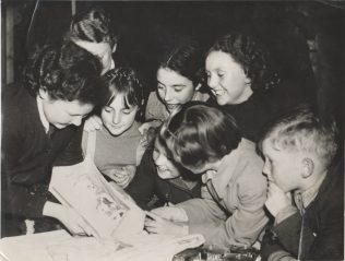 Children looking at a Doll, at the Christmas party
